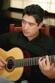 photo of Gilberto Gonzalez playing the guitar